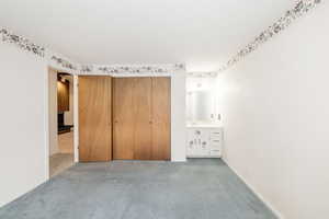 Unfurnished bedroom with carpet, a closet, and a textured ceiling