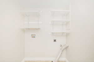 Laundry room featuring electric dryer hookup, washer hookup, and tile patterned floors