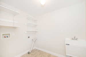 Washroom with hookup for an electric dryer and hookup for a washing machine