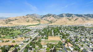 Aerial overview of property's location with a mountainous background and nearby suburban area