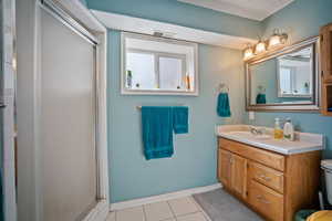 Full bathroom featuring tile patterned floors, a stall shower, vanity, and a textured ceiling