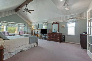 Bedroom featuring carpet, high vaulted ceiling, beam ceiling, and ceiling fan
