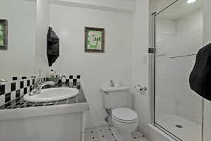 Full bath featuring vanity, a shower stall, and tile patterned flooring
