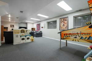 Game room featuring baseboards and carpet