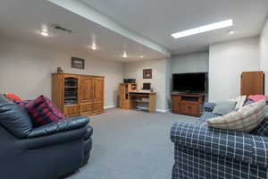 Living room with carpet flooring and recessed lighting