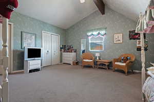 Sitting room with wallpapered walls and carpet flooring