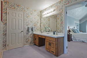 Ensuite bathroom with double vanity and wallpapered walls