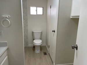 Full bath featuring wood finished floors and vanity