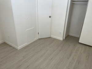 Unfurnished bedroom with light wood-type flooring