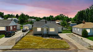 Bungalow-style house featuring a residential view and an outbuilding