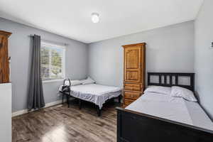 Bedroom with wood finished floors and baseboards