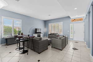 Living room featuring light tile patterned floors, healthy amount of natural light, and recessed lighting