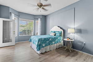 Bedroom with wood finished floors and ceiling fan