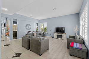 Living area with baseboards and light wood-style flooring