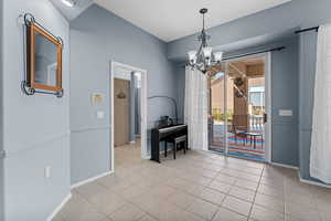 Dining space featuring a chandelier and light tile patterned flooring