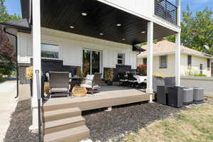 Patio / terrace featuring an outdoor living space, a wooden deck, and outdoor dining area