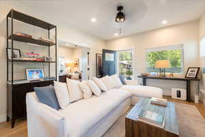 Living room with light wood finished floors, recessed lighting, and ceiling fan