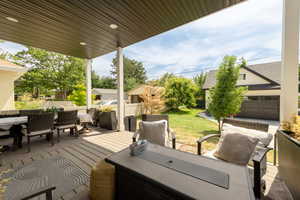 View of patio featuring outdoor dining area, outdoor lounge area, and a deck