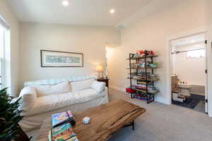 Living area with recessed lighting, carpet floors, and lofted ceiling