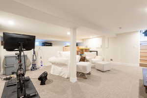 Workout area featuring baseboards and carpet