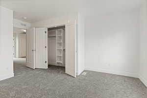 Unfurnished bedroom with carpet floors