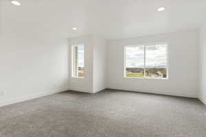 Empty room with carpet flooring and recessed lighting