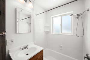 Bathroom featuring vanity and shower / bath combination