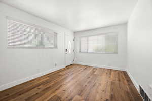 Foyer entrance with wood finished floors and baseboards