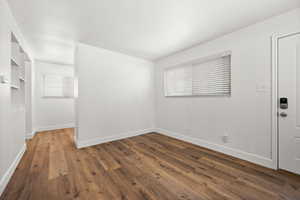 Empty room featuring wood finished floors and baseboards