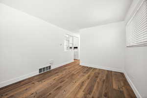 Empty room with wood finished floors and baseboards