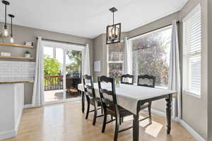 Dining room featuring light wood-type flooring and a chandelier