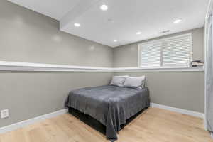 Bedroom featuring wood finished floors and recessed lighting