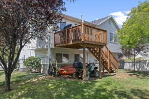 Back of property with a wooden deck and stairway