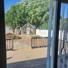 Wooden terrace featuring an outbuilding