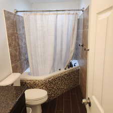 Bathroom featuring tiled shower / bath and vanity