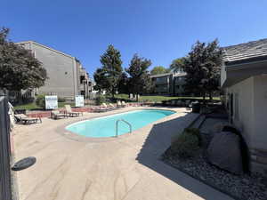 Community pool with a patio