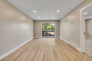 Empty room featuring recessed lighting and light wood-type flooring