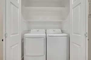Laundry room with washing machine and clothes dryer