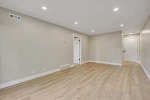 Spare room with recessed lighting and light wood-type flooring