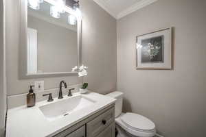 Bathroom featuring ornamental molding and vanity