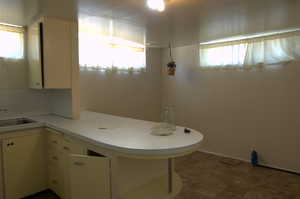 Bathroom with a sink and baseboards