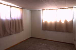 Empty room featuring carpet floors and baseboards