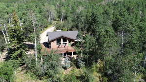 View of property location featuring a forest