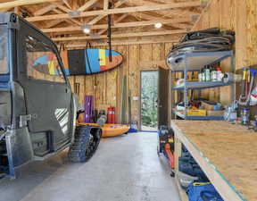 Garage featuring a workshop area and wooden walls