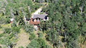 Aerial view of property's location with a heavily wooded area