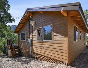 View of side of home featuring a wooden deck and stairway