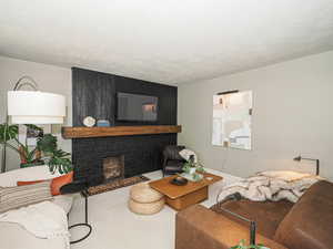 Living room with carpet and a large fireplace