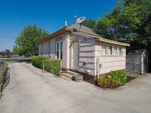 View of property exterior with a shed
