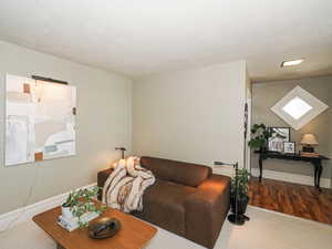 Living area featuring baseboards and wood finished floors