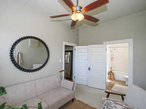 Carpeted living area with a textured ceiling and a ceiling fan